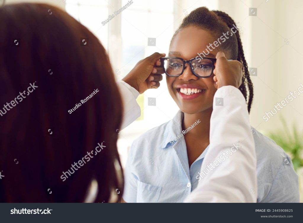 medcare vacances - stock photo examining eyeglasses happy african american female patient trying on glasses as recommended by 2445908625